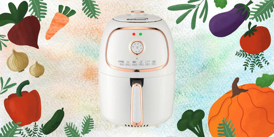 White and rose gold air fryer convection oven with colorful vegetable illustrations on a multicolored background.