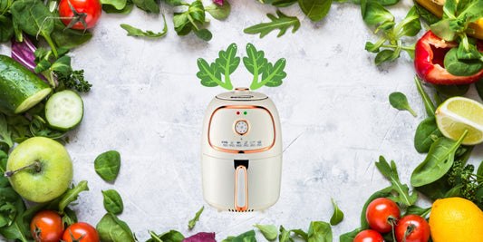 Small white appliance with green leaves on a background of fresh vegetables-showing air frying health bennefits in action.