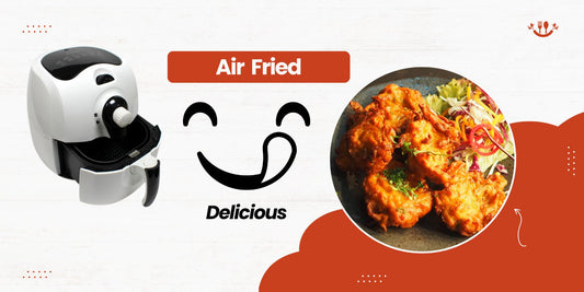 Countertop air fryer with air fried food on a white background.